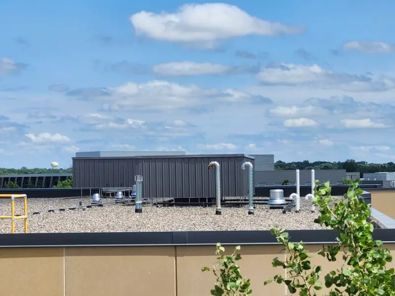 Low-rise commercial roof showing mechanical equipment arranged for screening from public view