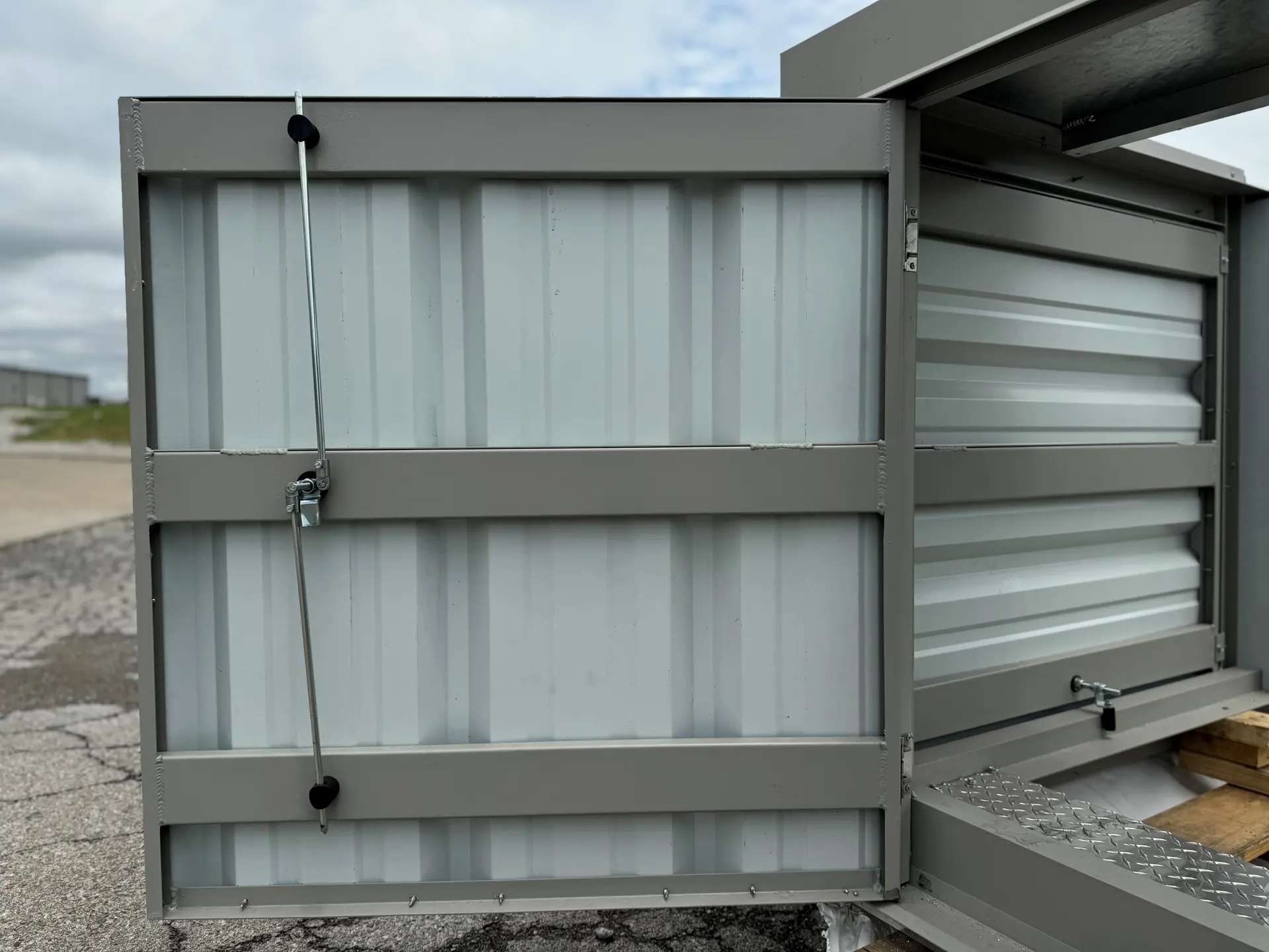 Hinged service access door detail on a steel rooftop equipment screen