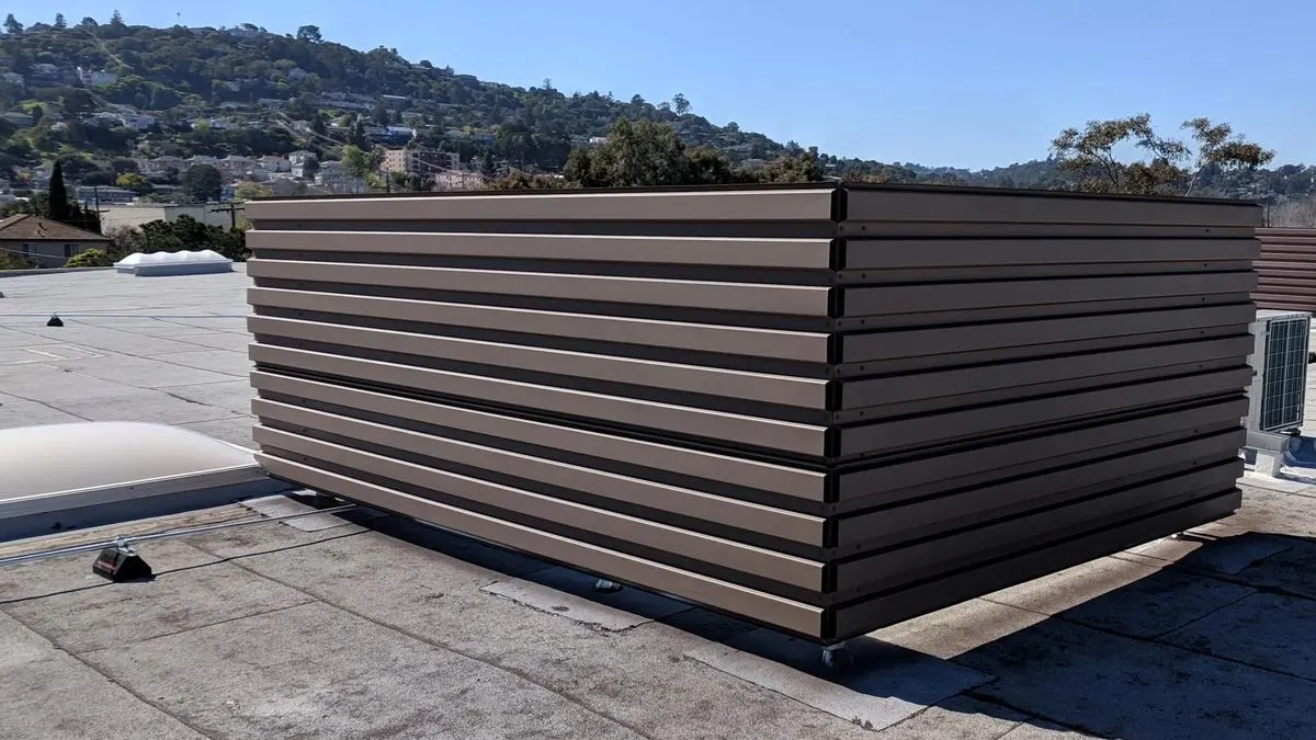Non-penetrating rooftop HVAC screens with ballasted base on a commercial roof